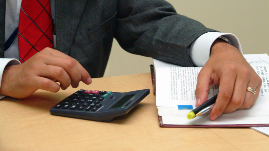 Construction manager reviewing prevailing wage determination time and PERM timeline planning on laptop.